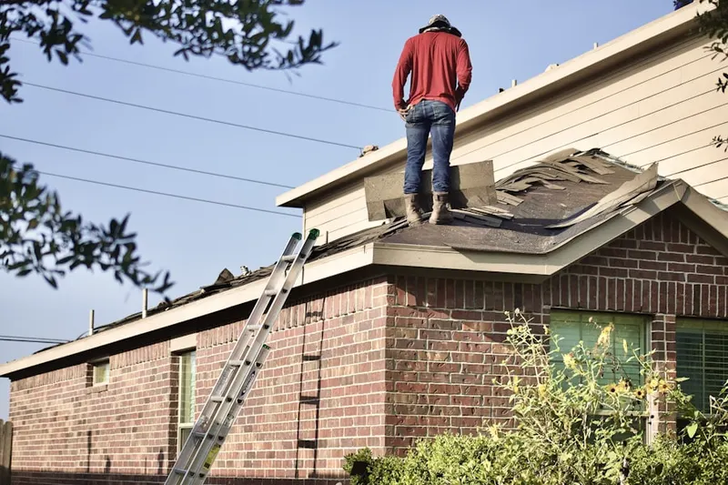 Professional roofer working on a residential roof in Millican